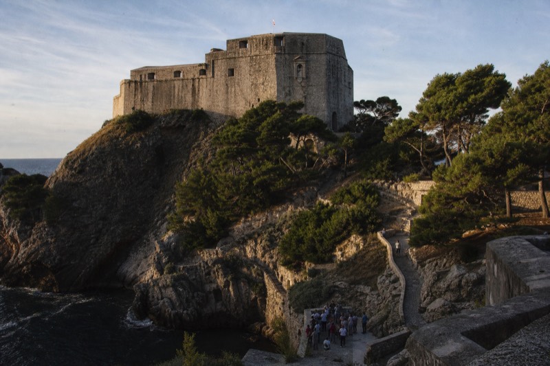 The grey stone fortress of Lovrijenac rising over the Adriatic at Dubrovnik, Croatia, late afternoon, harsh shadows across the medieval bastion walls