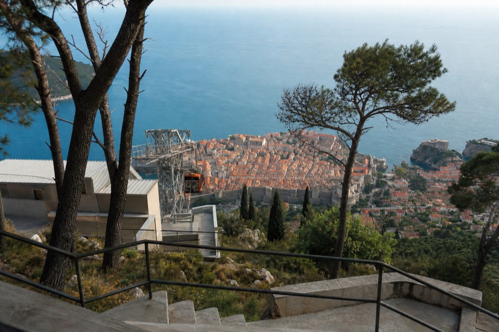 The lower cable car station beside the Old Town walls with the Adriatic stretching to the horizon