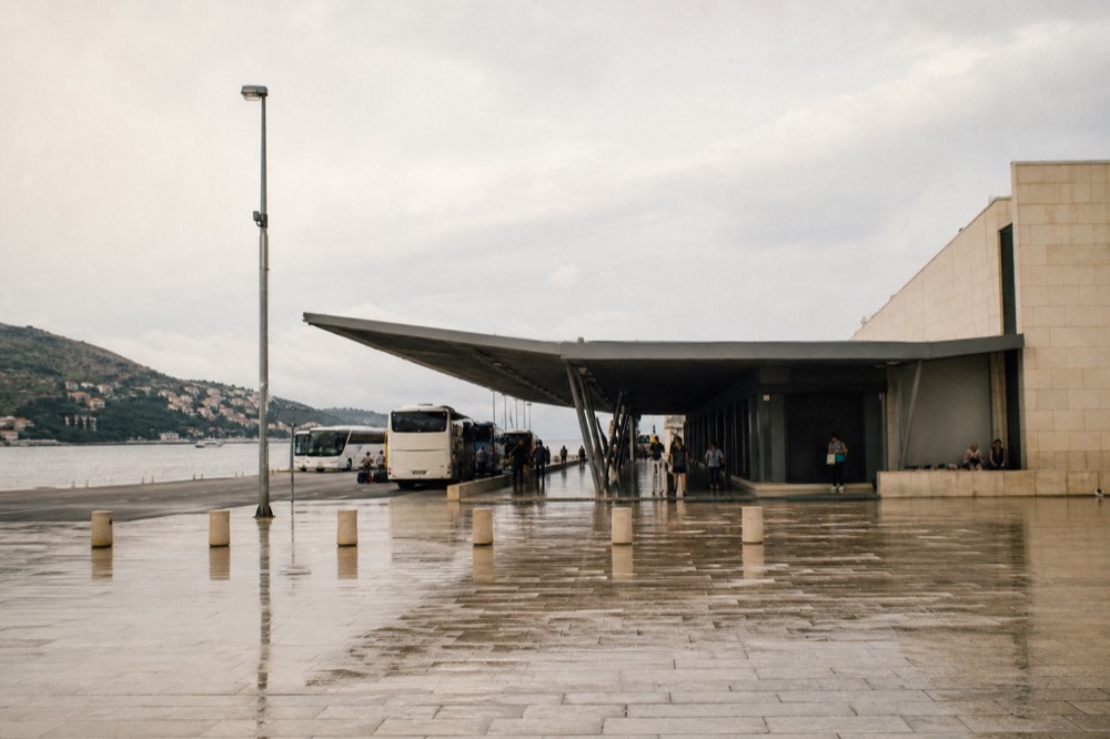 Cruise terminal building at Gruž with parked buses and the Adriatic behind