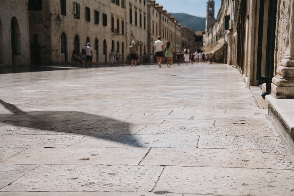 The limestone Stradun street stretching through Dubrovnik Old Town with baroque buildings on both sides