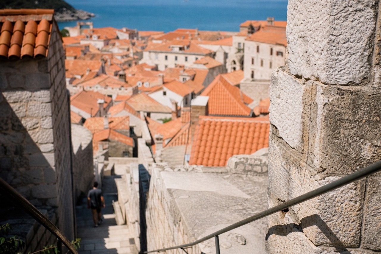 Stone staircase and terracotta rooftops of Dubrovnik Old Town seen from the city walls