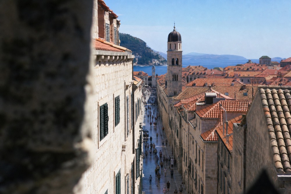 A wide limestone street in Dubrovnik Old Town lined by stone buildings in morning light