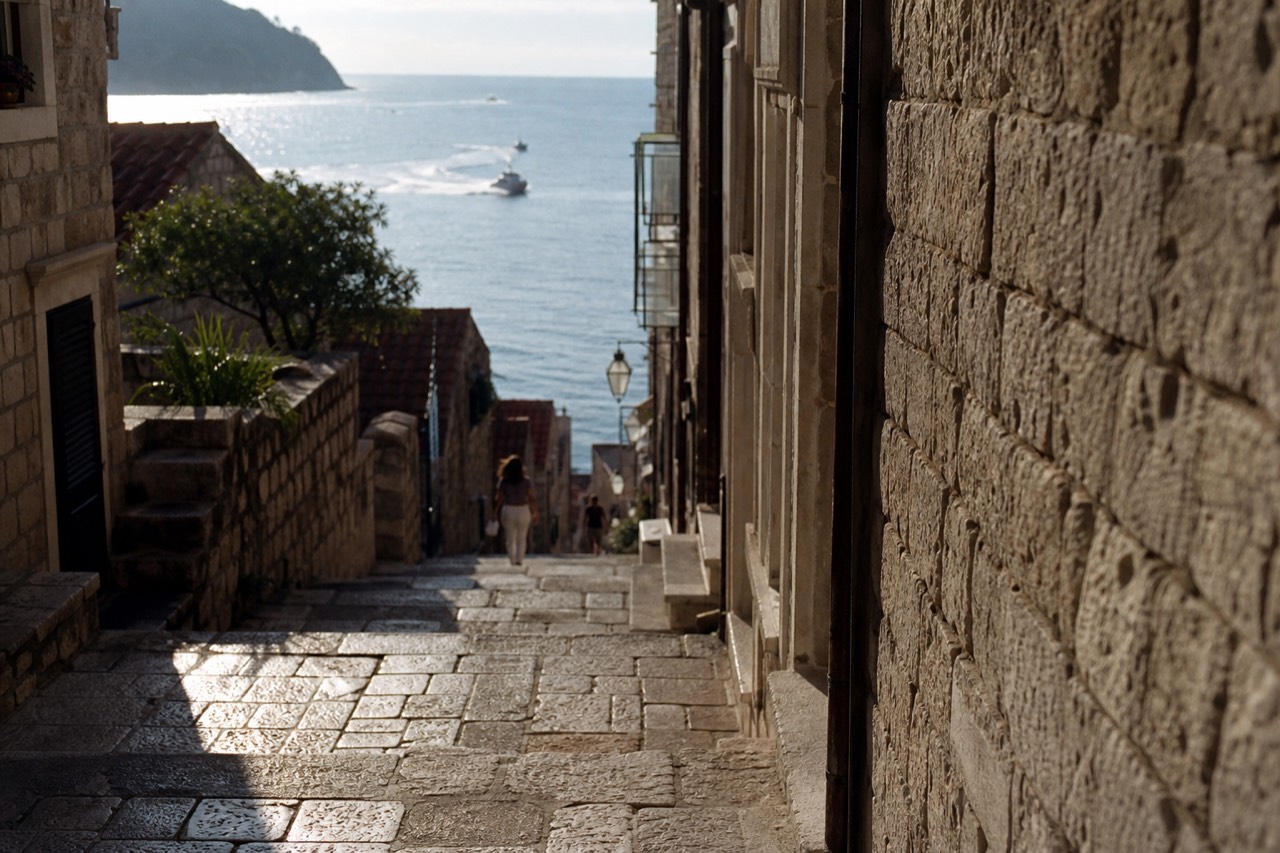 A quiet stone street in Dubrovnik Old Town with warm afternoon light on the paving