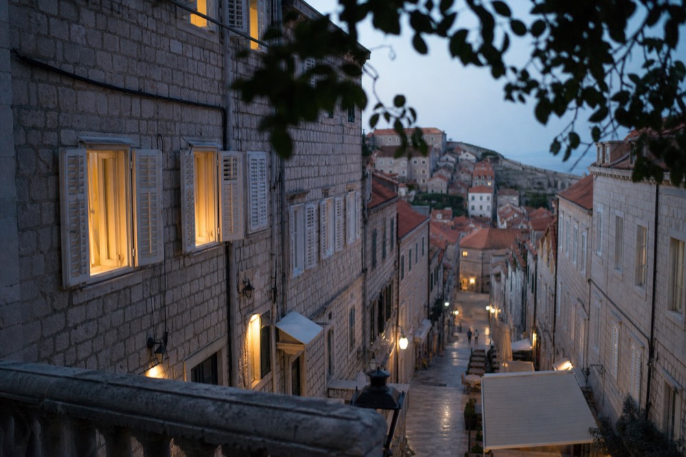 A quiet limestone street inside Dubrovnik Old Town in early morning light