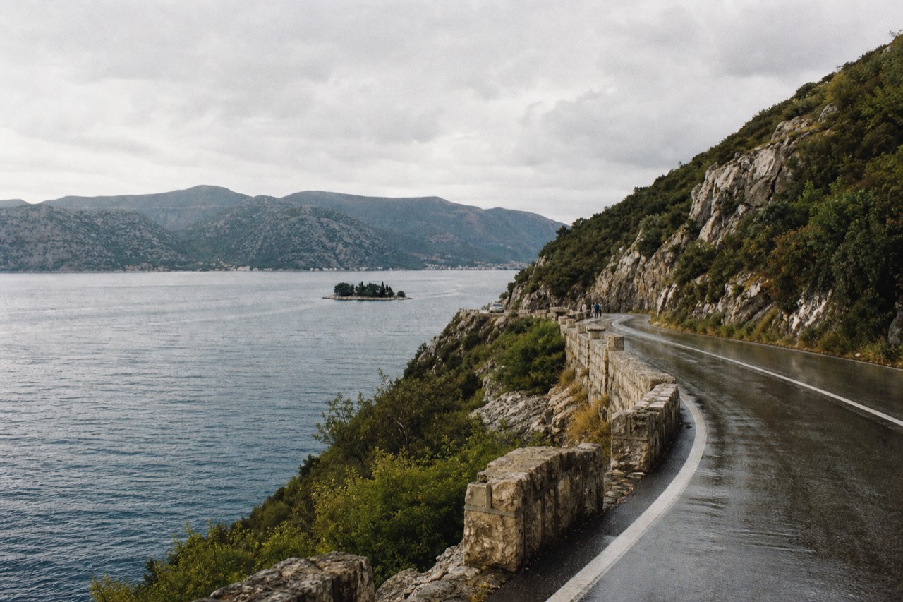 Coastal road winding along steep hills above the Adriatic sea near the Croatia and Montenegro border