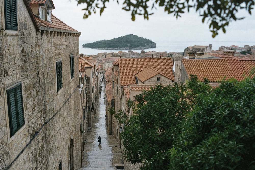 Limestone paved street in Dubrovnik Old Town lined with stone buildings in morning light