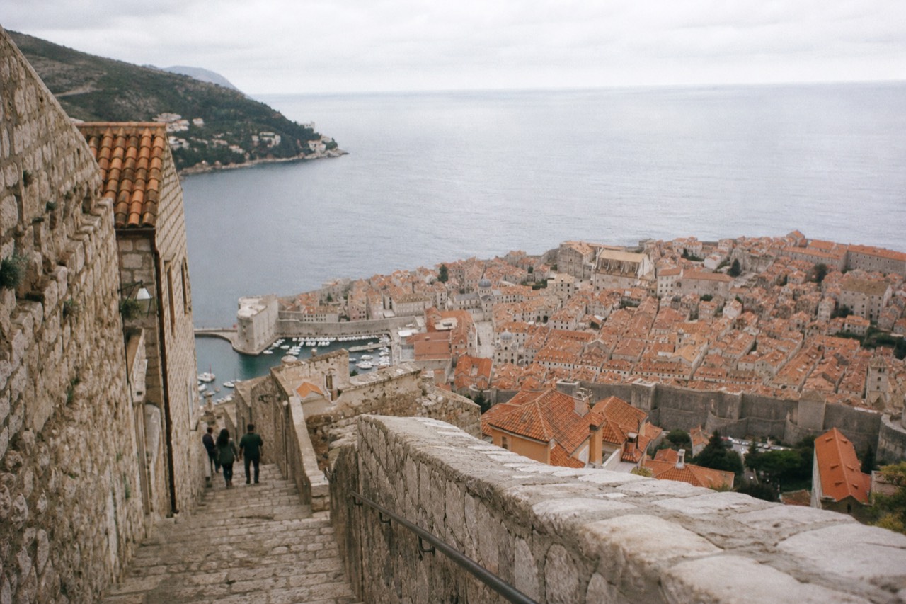 Stone buildings and terracotta roofs of Dubrovnik Old Town seen from the city walls above the Adriatic