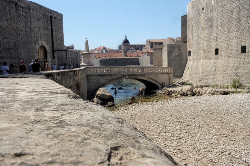 Pile Gate drawbridge and stone bridge with the Old Town walls and St Blaise statue visible