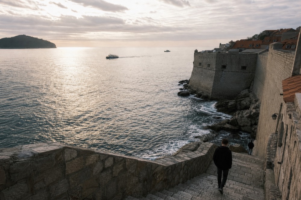 The Adriatic sea breaking against the stone walls of Dubrovnik on a calm overcast winter morning