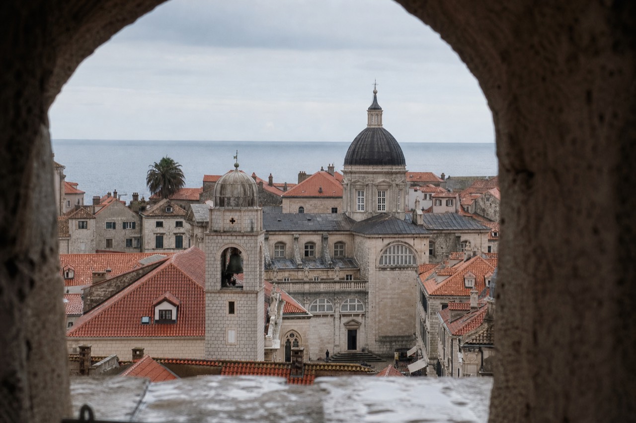 Baroque church towers rising above the red rooftops of Dubrovnik Old Town