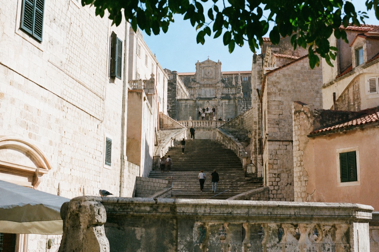 A wide view of the Jesuit Stairs in Dubrovnik, with the baroque Church of St. Ignatius at the top.
