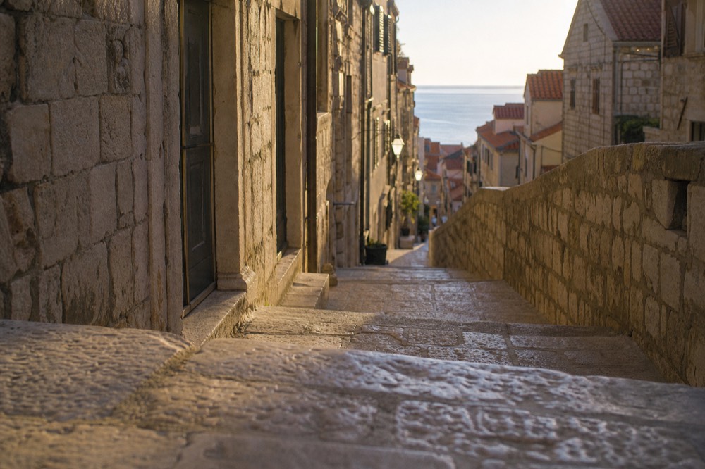 Empty stone staircase street in Dubrovnik Old Town in early morning light