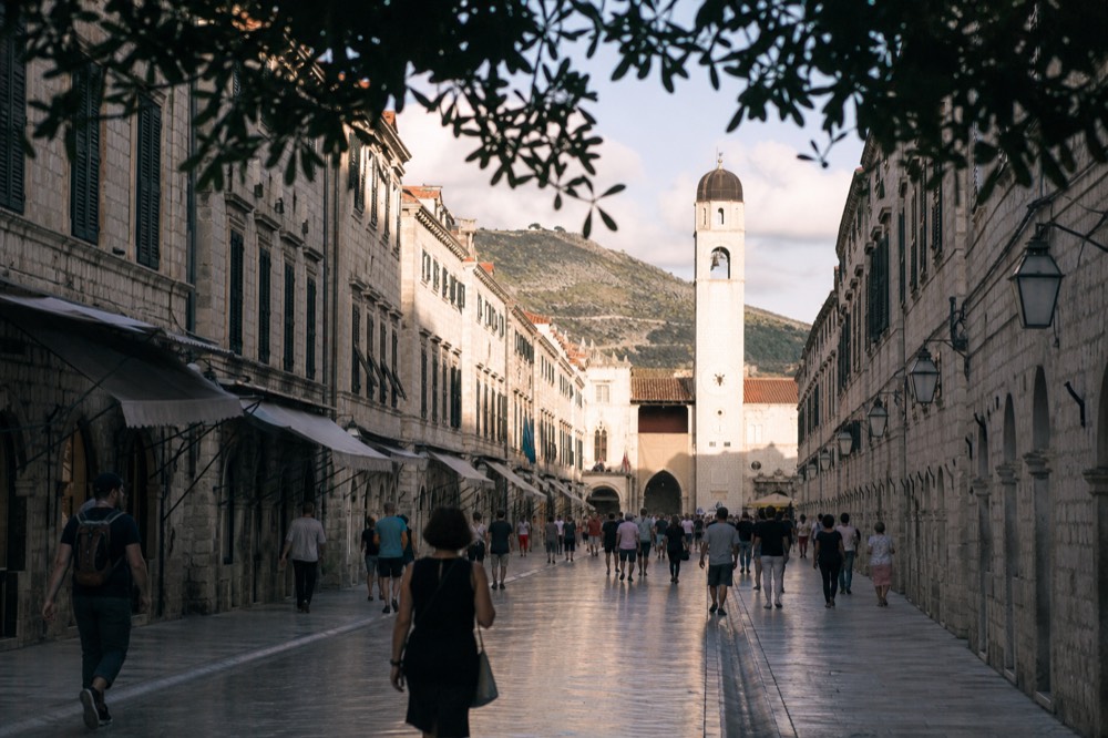 The limestone-paved Stradun street stretching toward the clock tower in Dubrovnik Old Town