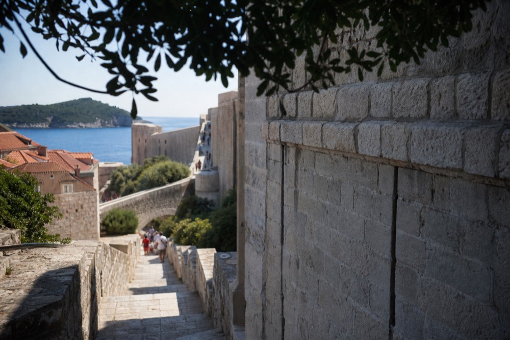 A section of the city walls showing the layered limestone blocks, their surface weathered to a soft grey-white