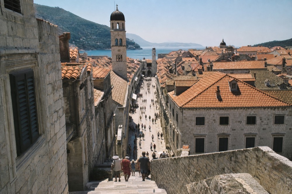 The limestone Stradun street in Dubrovnik Old Town lined with stone buildings under a clear sky