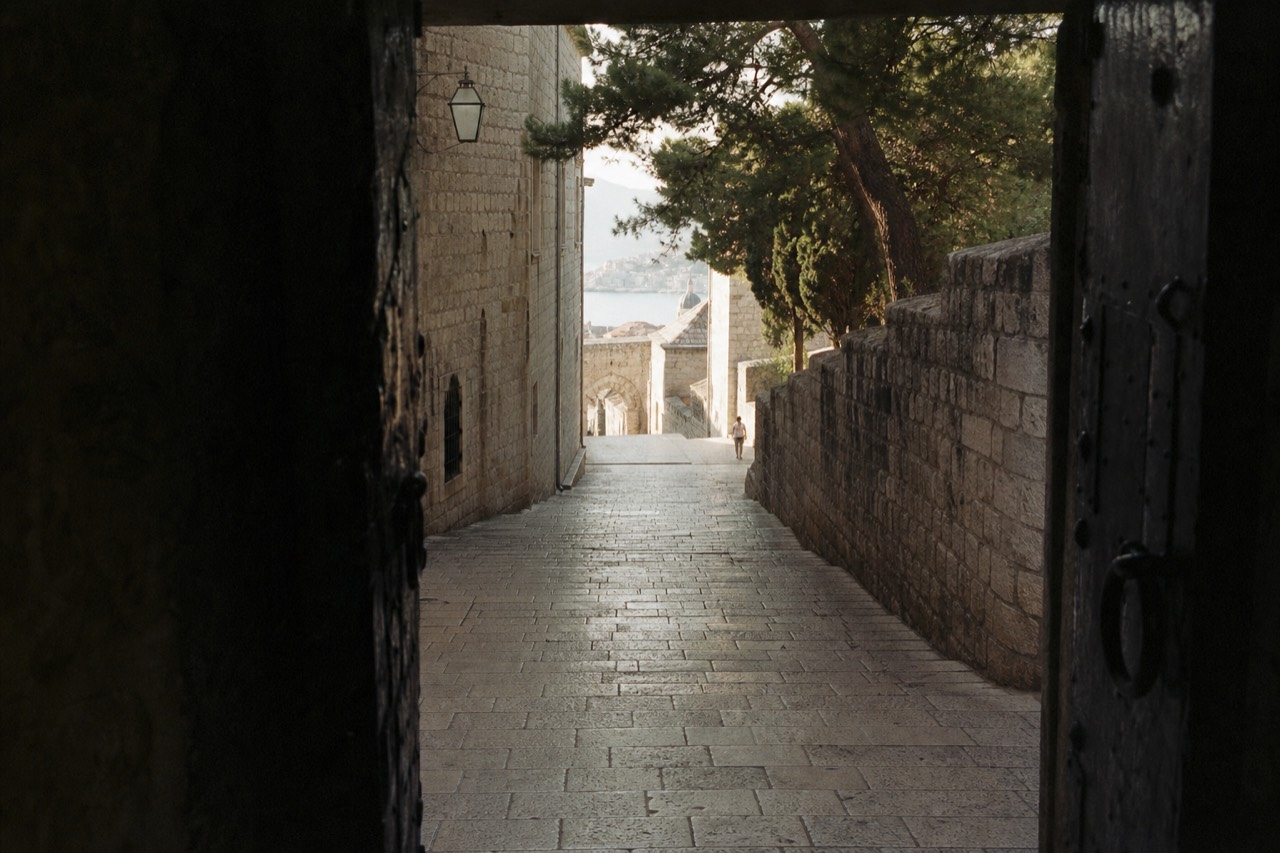 Empty limestone street inside Dubrovnik Old Town in early morning light