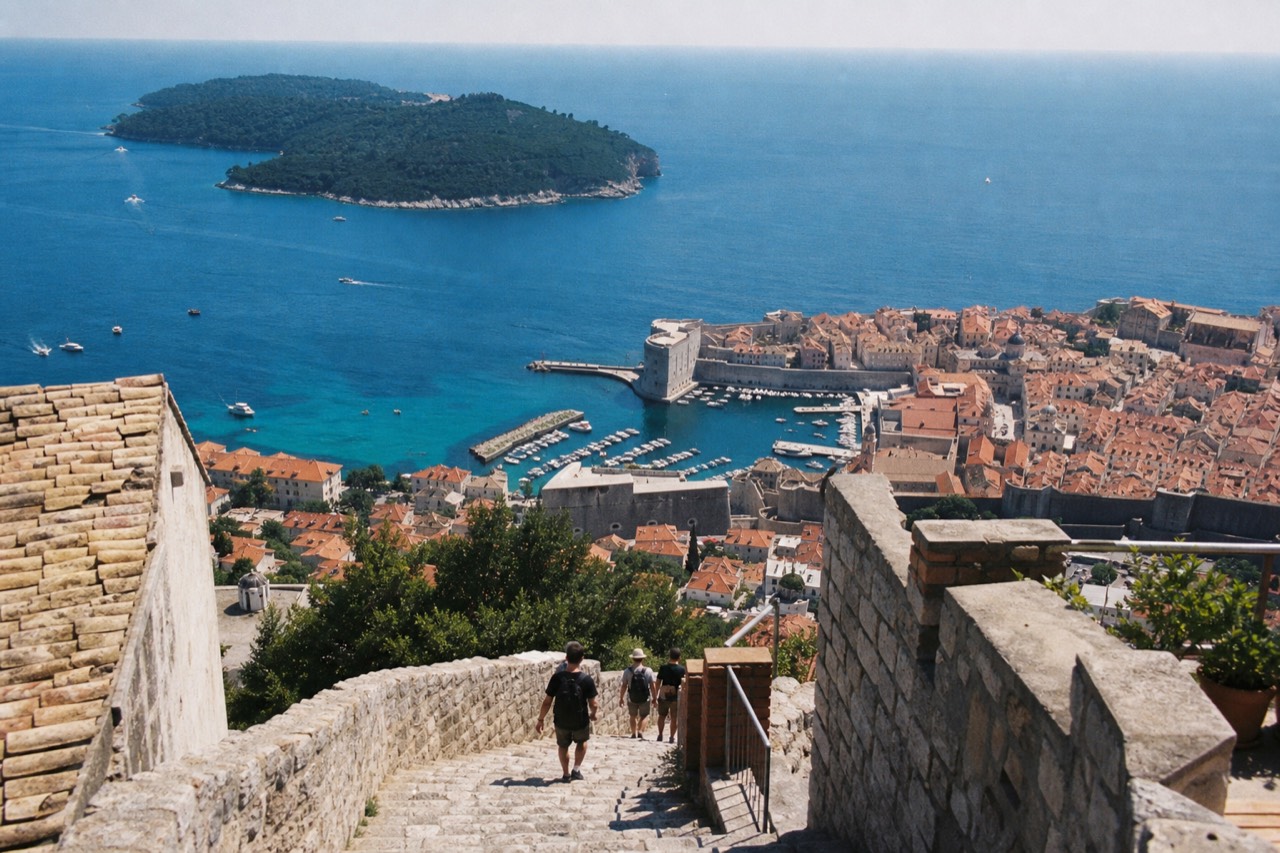 Aerial view of Dubrovnik Old Town showing the red rooftops, city walls, and the Adriatic Sea