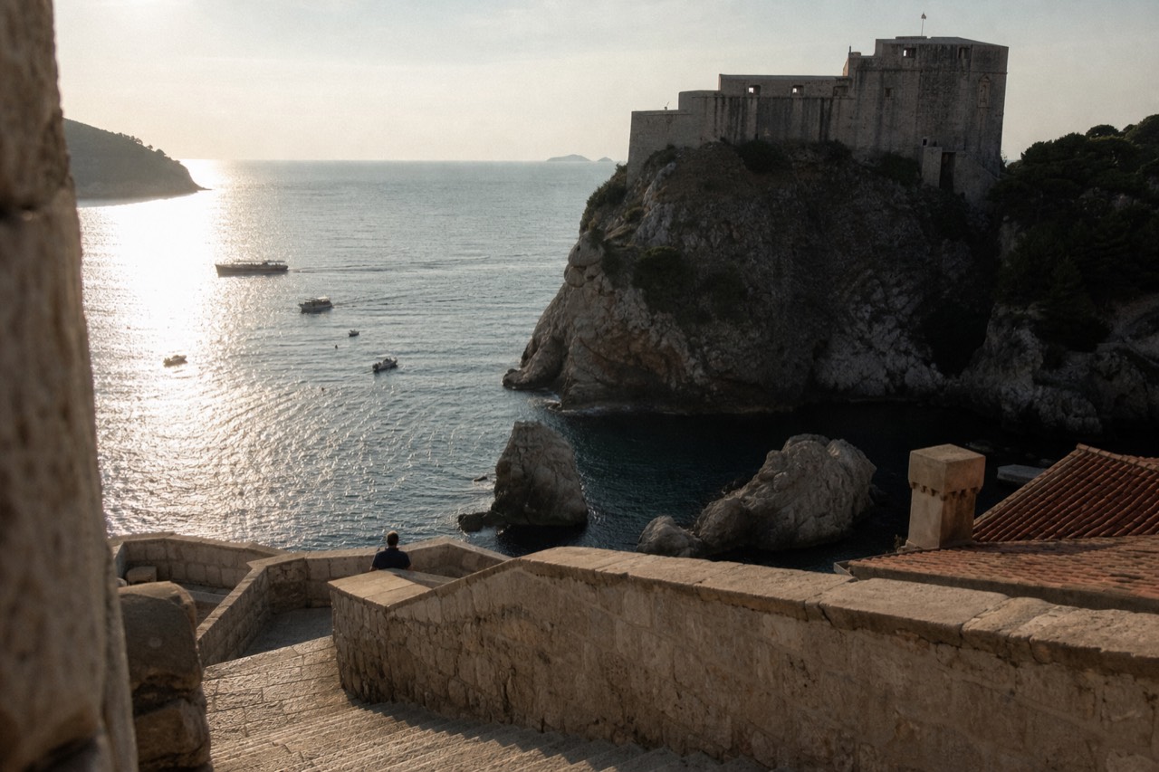 Stone fortress on a rocky cliff above the sea near the old walled town