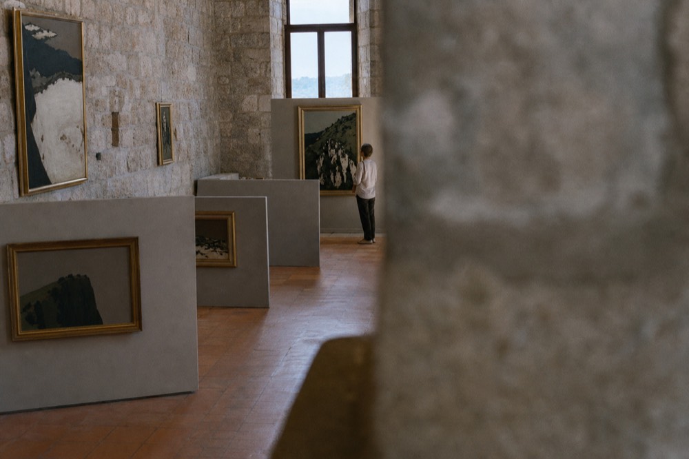 Gallery hall with framed paintings and stone walls in a Dubrovnik museum