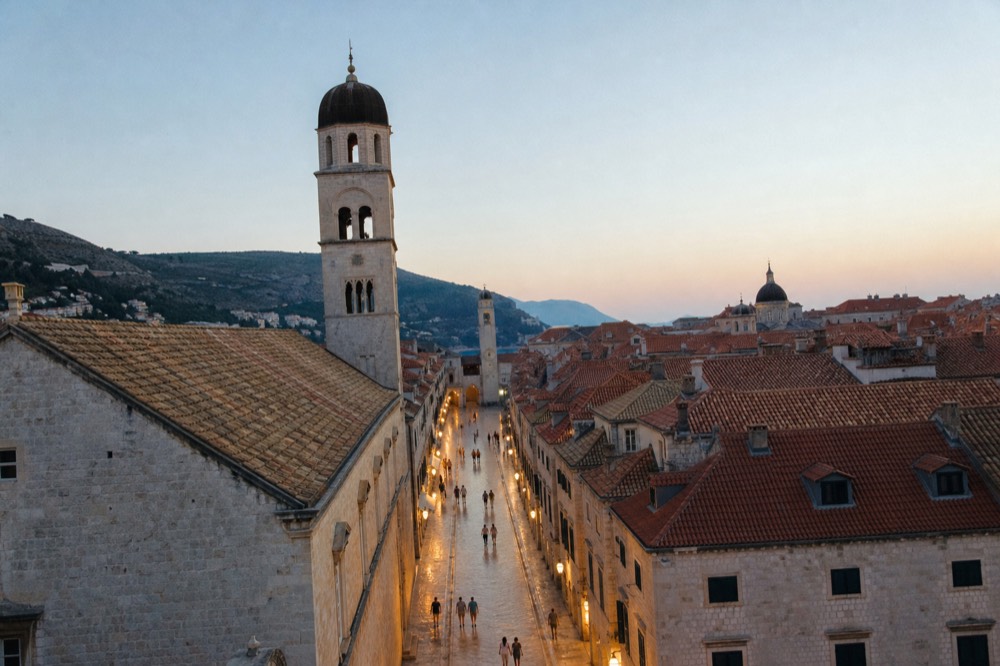 The Stradun at dusk with the limestone street polished and the Onofrio Fountain at the far end