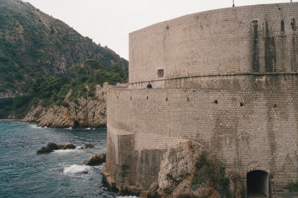 Stone fortifications of Dubrovnik rising above the sea outside Pile Gate
