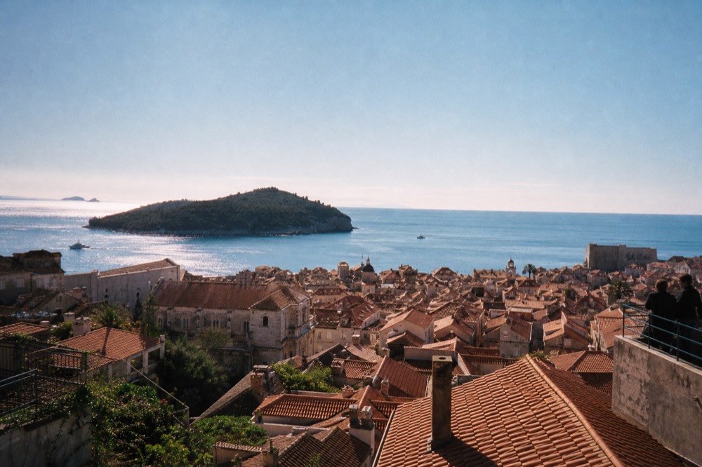 View from a Ploče terrace over the Old Town rooftops toward Lokrum island at midday
