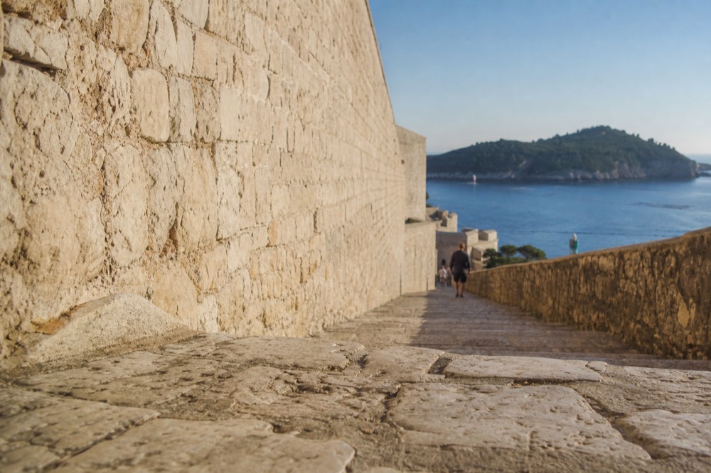 The eastern city wall above the sea with Lokrum island and the open Adriatic beyond