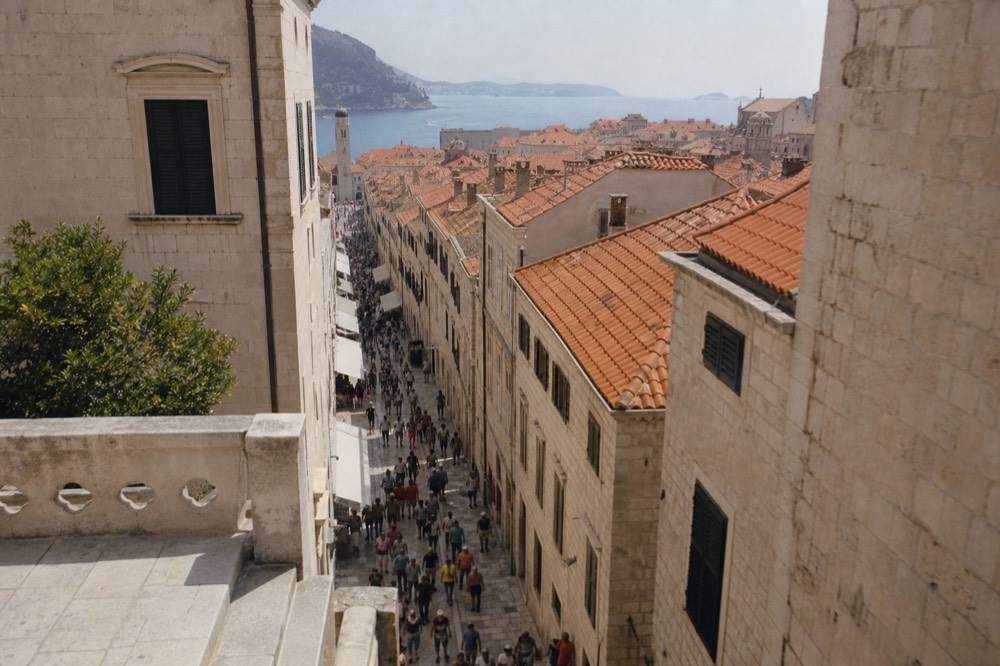 Crowded limestone street in Dubrovnik Old Town at midday