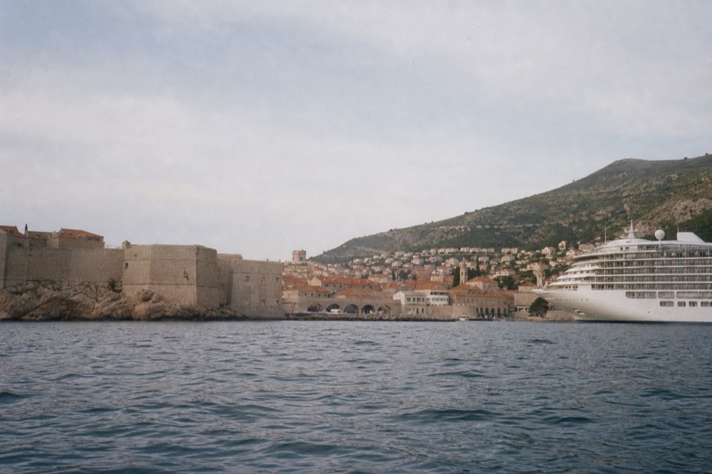 Cruise ship anchored outside Dubrovnik Old Town harbour in morning light