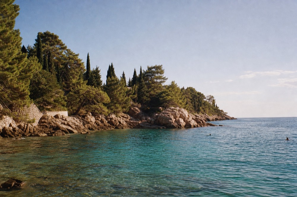 Clear turquoise water at a rocky cove near Dubrovnik with gentle morning waves