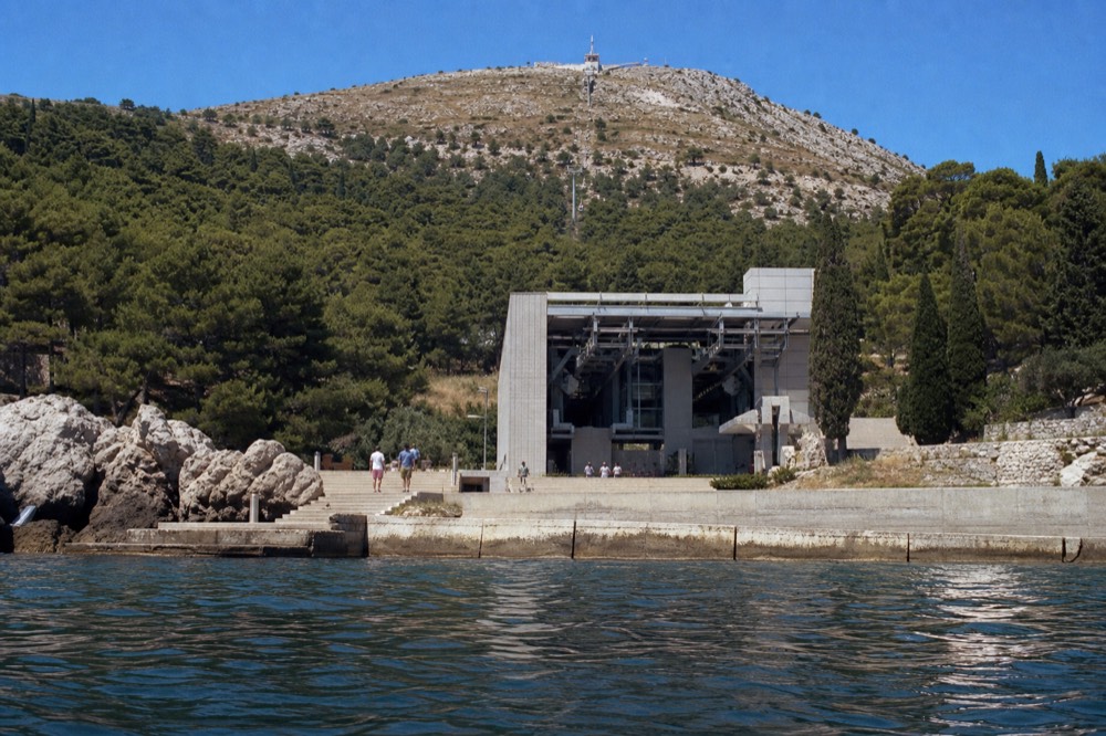 Cable car lower station building near the Old Town with the steep wooded slope of Mount Srd behind