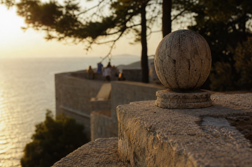 Golden sunset light over the Adriatic sea seen from a stone terrace