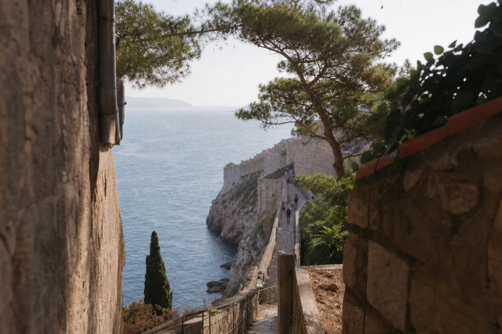 Narrow stone staircase along the wall top with the sea on one side