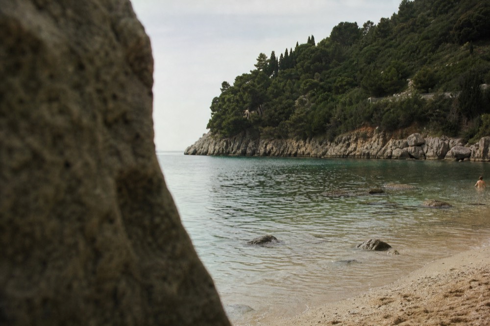 Clear shallow water over pale sand with gentle ripples in morning light