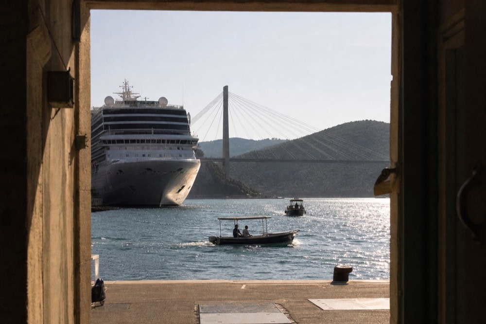 Cruise ship docked at Gruž port with the Franjo Tuđman Bridge in the background