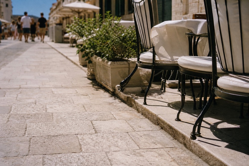 Cafe tables on a limestone street in Dubrovnik Old Town