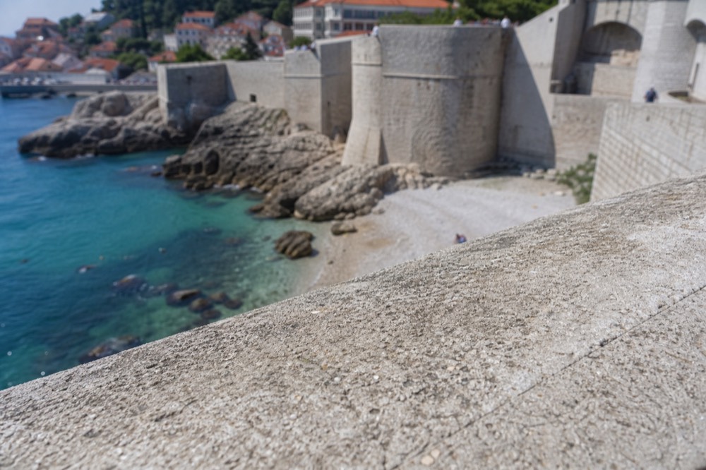 Stone fortifications of the Dubrovnik city walls seen from a rooftop terrace above the Old Town