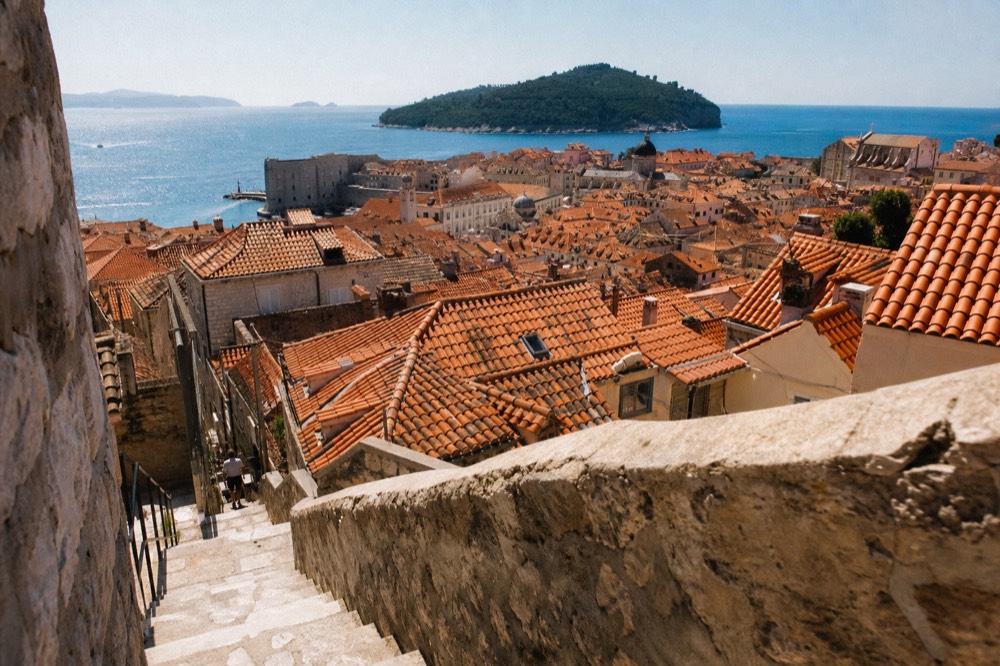 Rooftops of Dubrovnik Old Town with terracotta tiles and the Adriatic sea behind