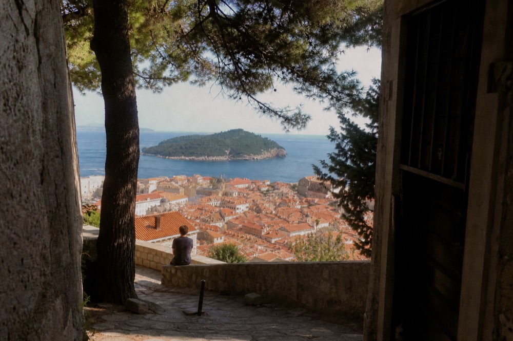 Red rooftops of Dubrovnik Old Town seen from above with the Adriatic and Lokrum island beyond