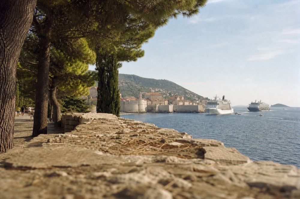 Cruise ships anchored off Dubrovnik Old Town seen across the water