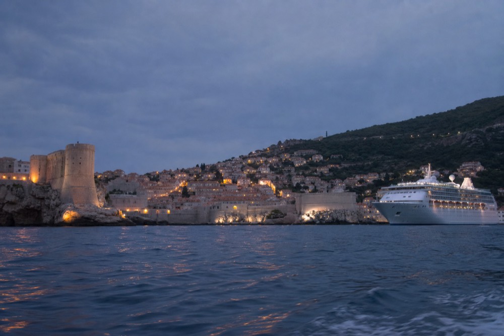 Cruise ship anchored off Dubrovnik Old Town with the walled skyline behind