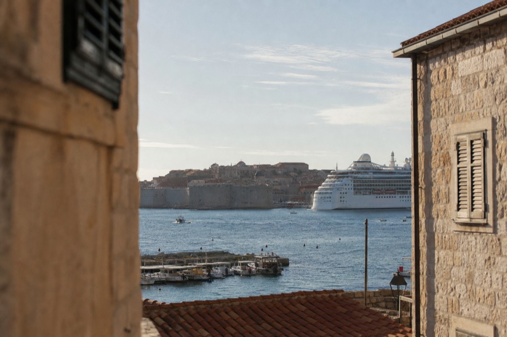 Cruise ship anchored off Dubrovnik Old Town with the walled city behind