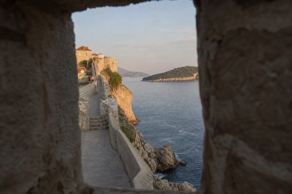 Golden evening light on Dubrovnik's city walls and sea below