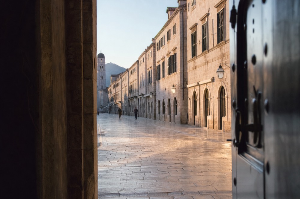 The Stradun in Dubrovnik Old Town in soft morning light with few pedestrians