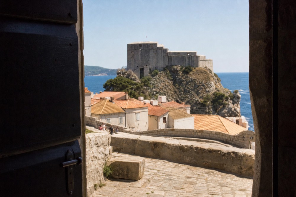 Fort Lovrijenac standing on its rock beyond the winter sea wall with grey water below