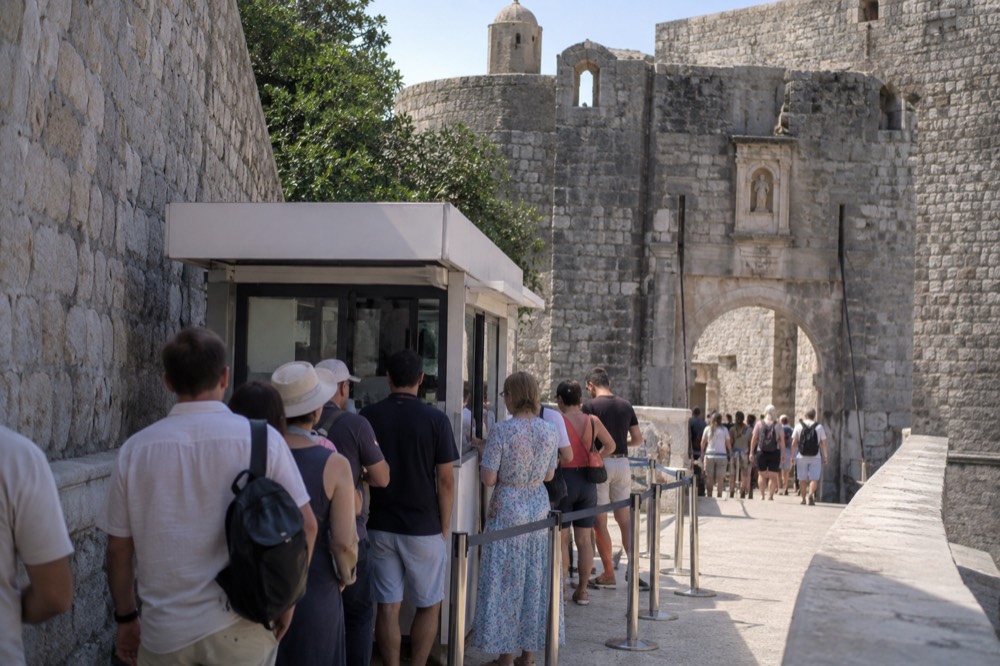 The Dubrovnik Pass kiosk at Pile Gate with a queue of visitors