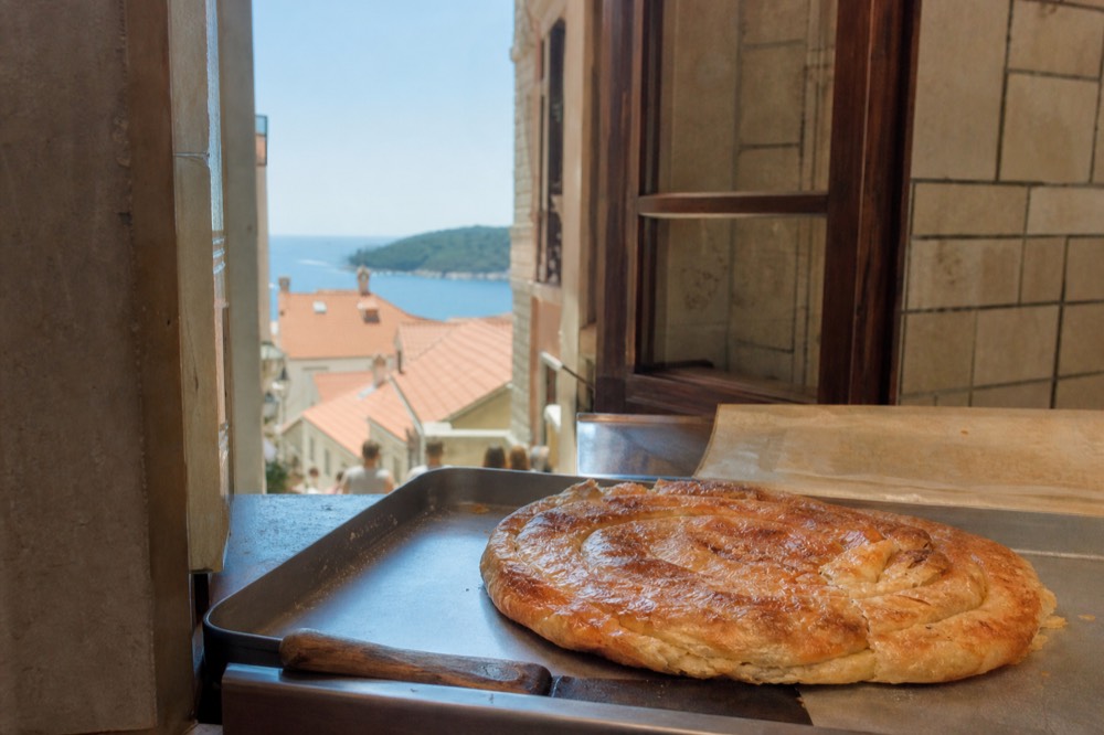 A cheese burek fresh from the oven on a bakery counter