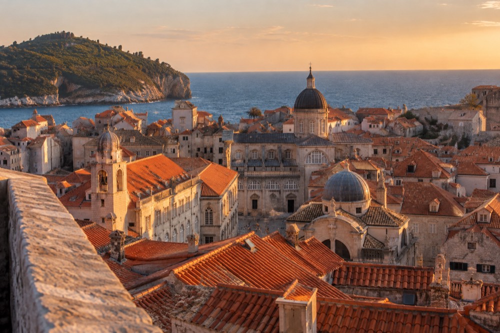 Evening light over the terracotta rooftops and church towers of the Old Town from a high viewpoint