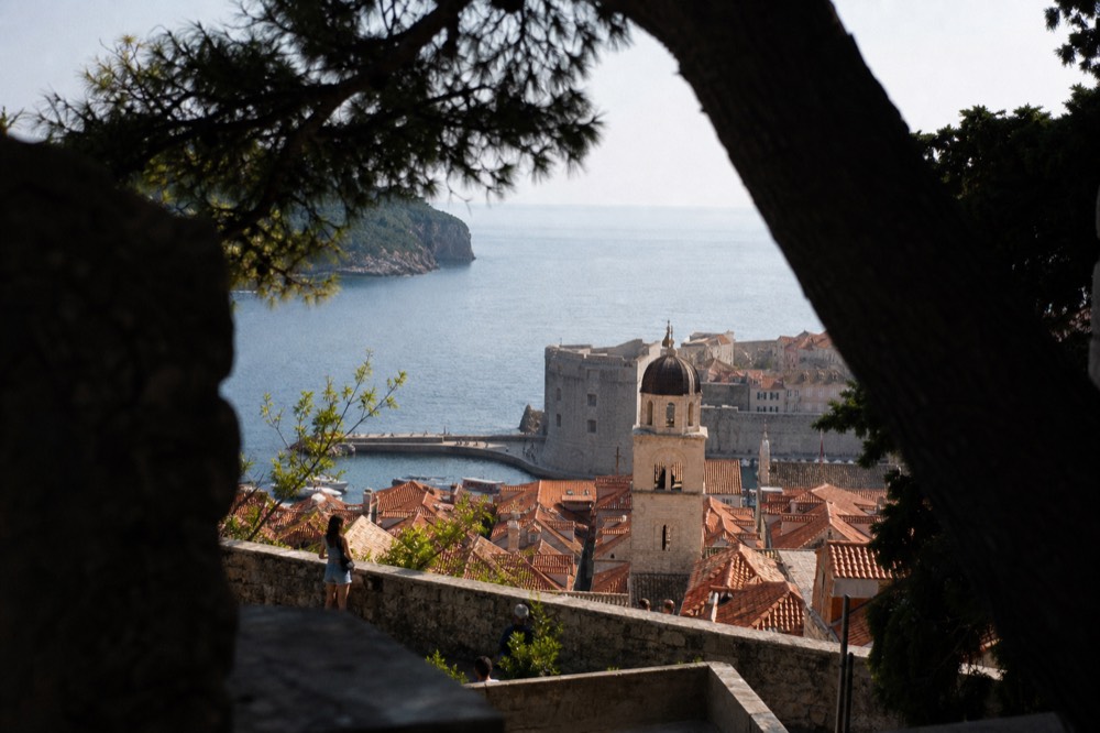 Rooftop terraces and church towers seen from a high stone wall