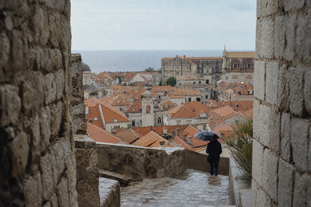 The terracotta rooftops of Dubrovnik Old Town seen from the city walls with the Adriatic on the horizon